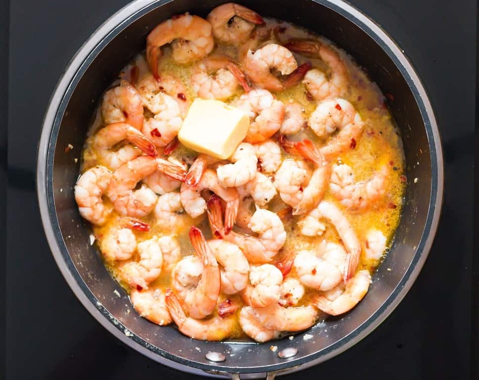 butter garlic shrimp cooked in a skillet.