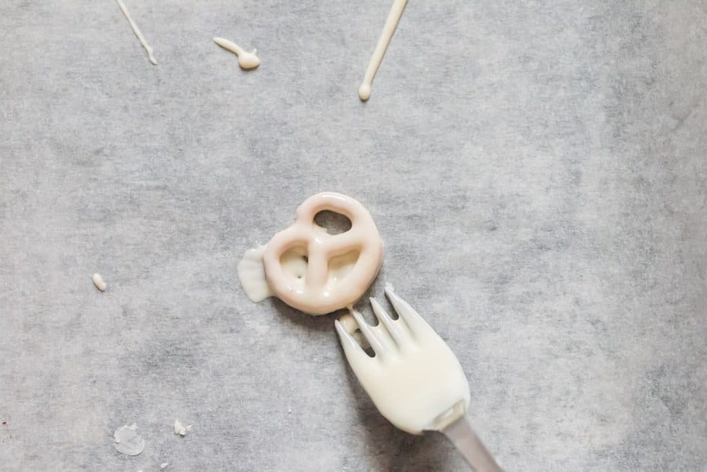 setting halloween pretzels on parchment paper to set