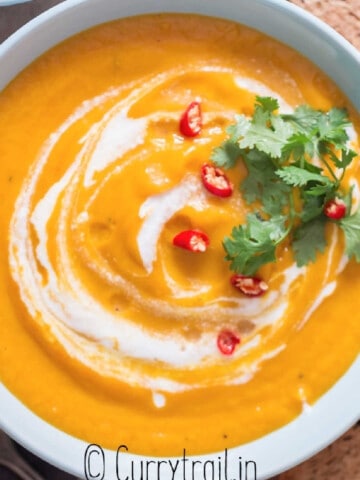 Thai vegan pumpkin curry soup with crusty bread on side