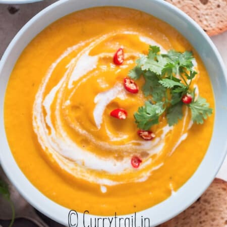 Thai vegan pumpkin curry soup with crusty bread on side