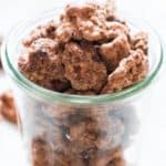 candied walnuts in glass jar with text overlay