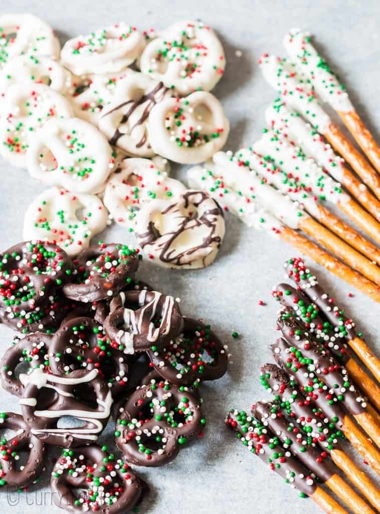 pretzels dipped in chocolate laid on parchment paper