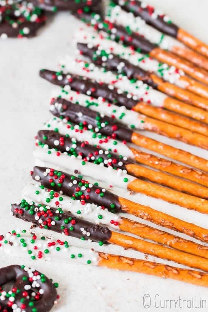 pretzels dipped in chocolate laid on parchment paper