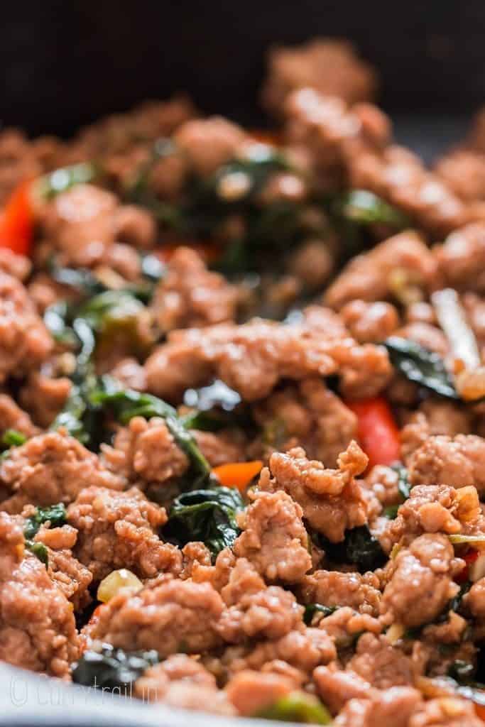 spicy Thai basil chicken in cast iron pan