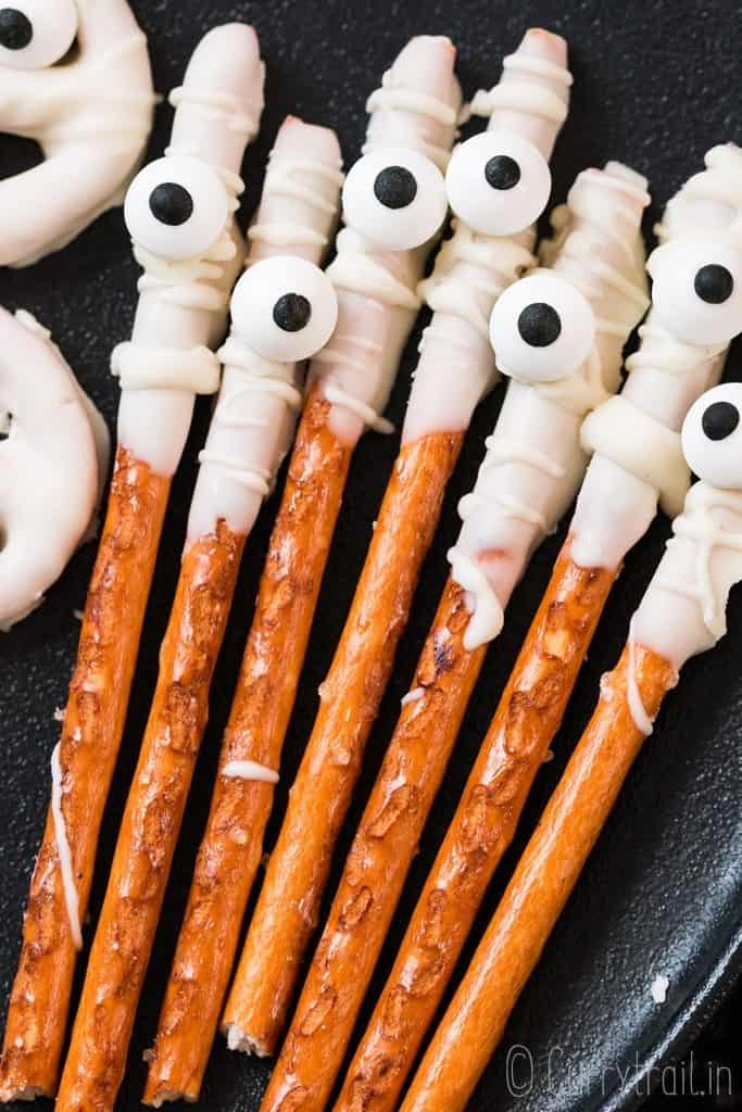 mummy pretzels rods on black plate