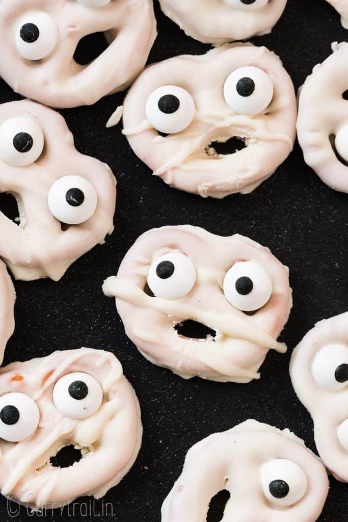 chocolate coated pretzels decorated like ghosts