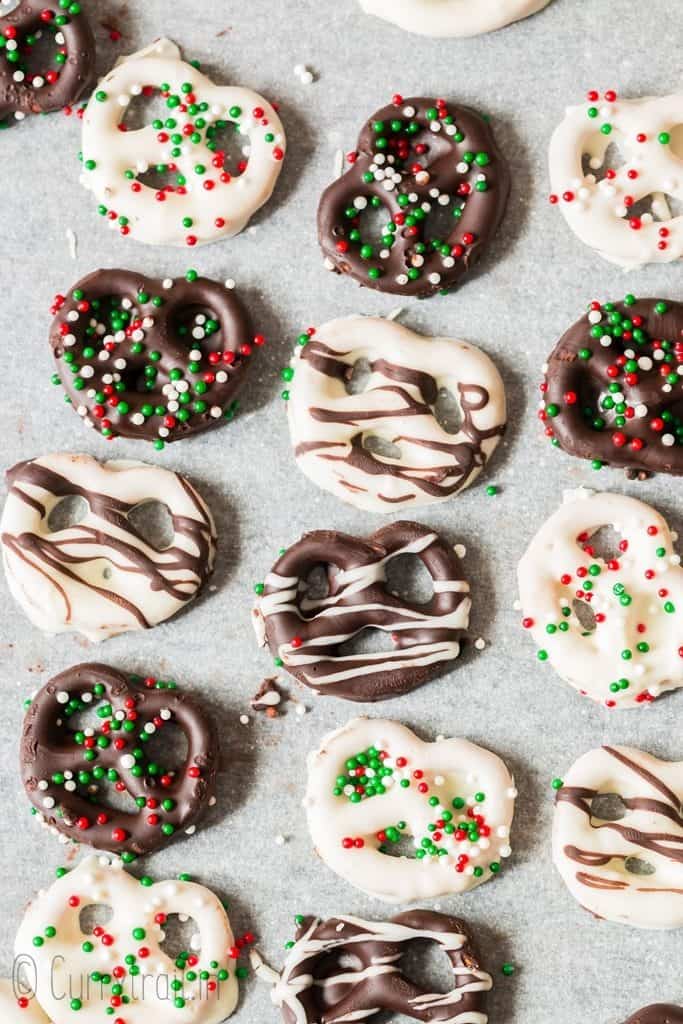 pretzels dipped in chocolate laid on parchment paper