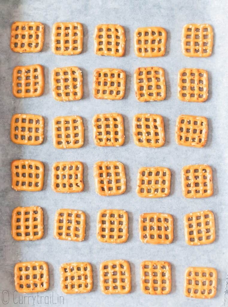 pretzel squares arranged on baking tray lined with parchment paper