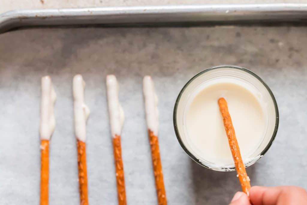 dipping pretzel rods in white chocolate