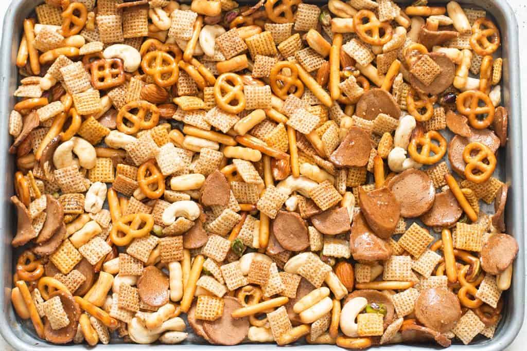homemade chex mix ingredients spread on baking tray