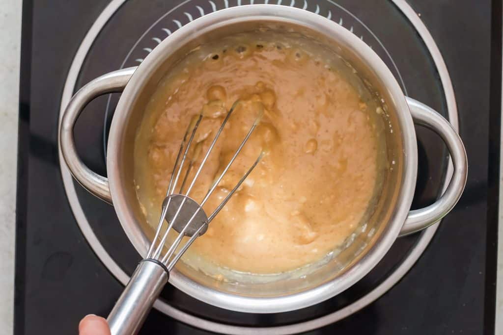 whisking peanut butter and corn syrup with sugar