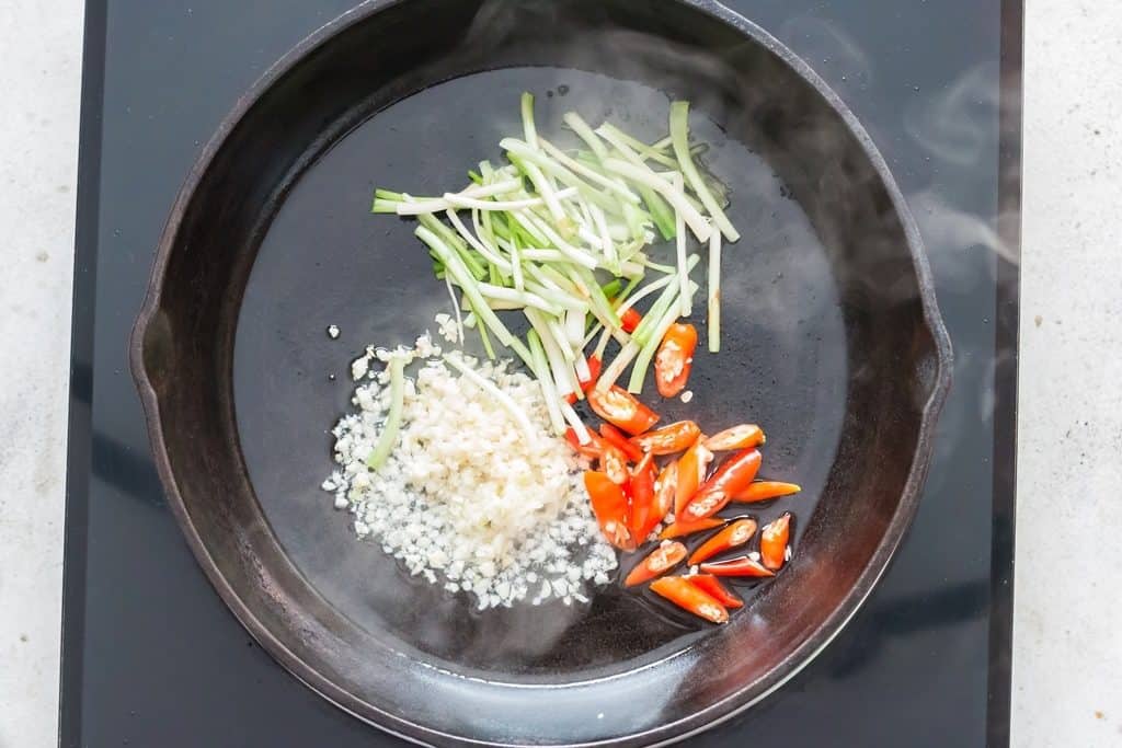 making Thai basil chicken in a pan