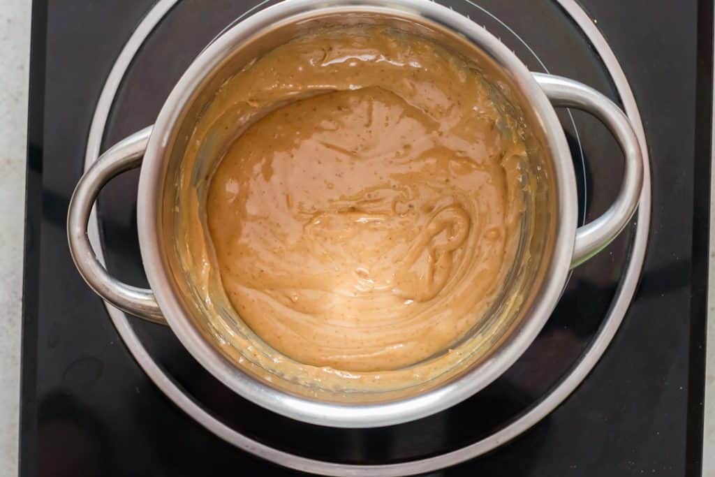 whisking peanut butter corn syrup in sauce pan