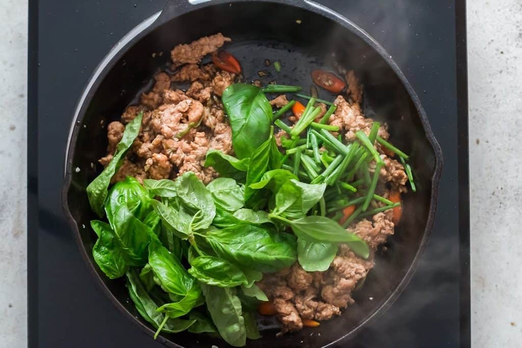 cooking Thai basil chicken in pan