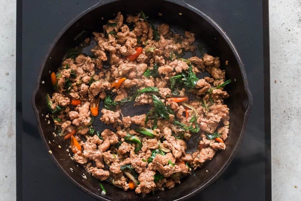 cooking Thai basil chicken in pan