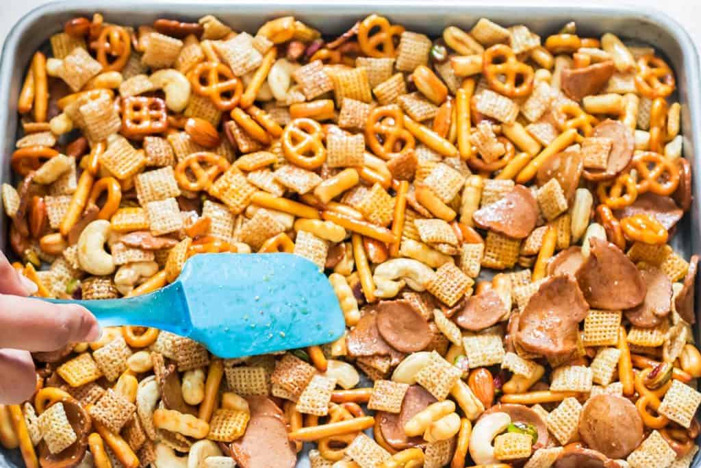 homemade chex mix ingredients spread on baking tray