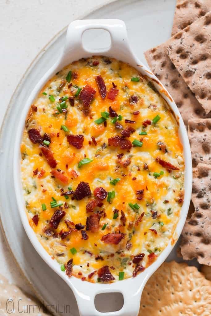 cream cheese dip served hot in a casserole with crackers on the side.