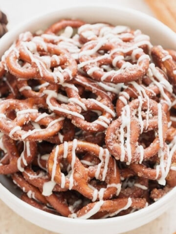 cinnamon sugar pretzels with white chocolate in a white bowl.
