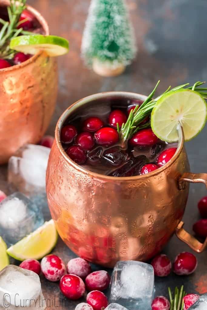 cranberry Moscow mule served in copper cups with ice, cranberries and lime