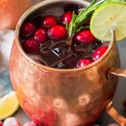 cranberry Moscow mule served in copper cups with ice, cranberries and lime
