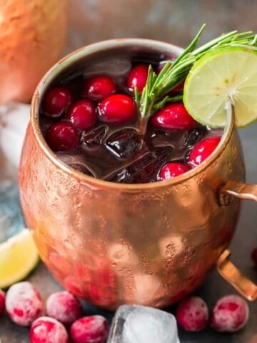 cranberry Moscow mule served in copper cups with ice, cranberries and lime