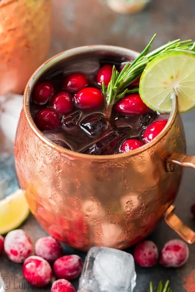 cranberry Moscow mule served in copper cups with ice, cranberries and lime