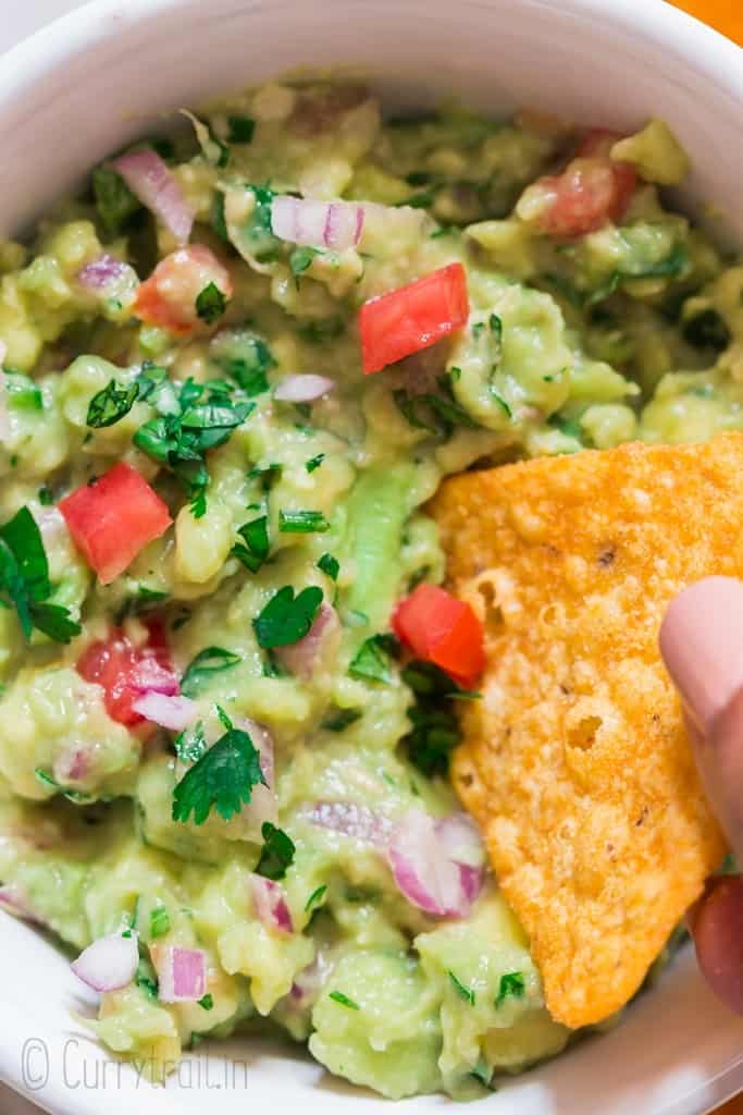 guacamole scooped with nachos