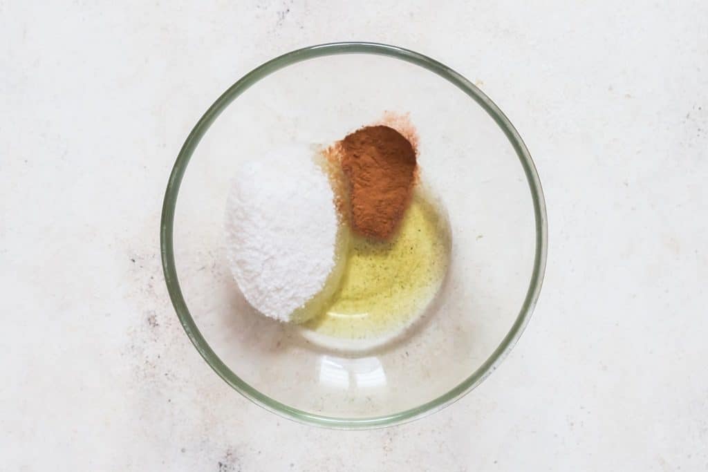 mixing oil cinnamon powder and sugar in a bowl.