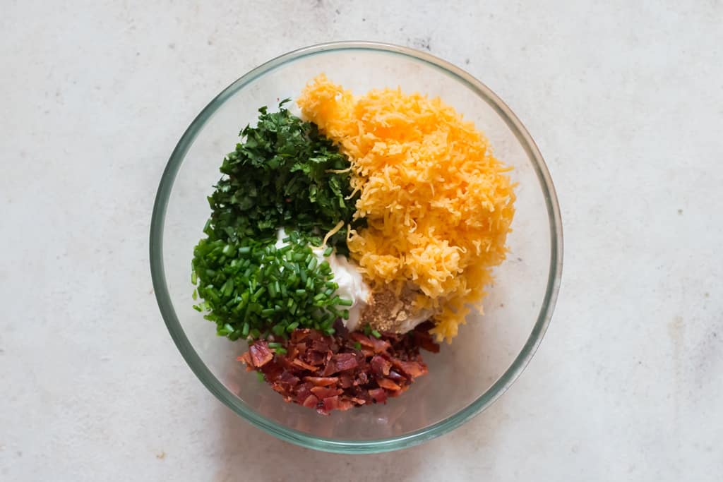 Mixing all ingredients for cream cheese dip in a bowl.