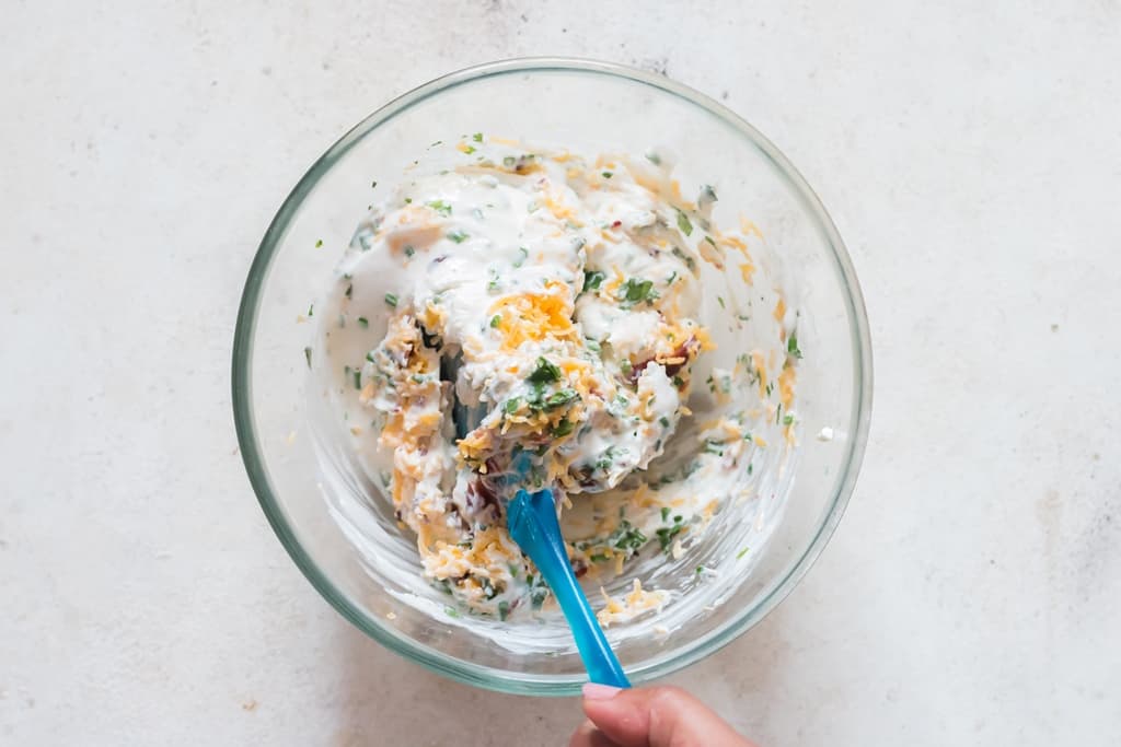 Mixing all ingredients for cream cheese dip in a bowl