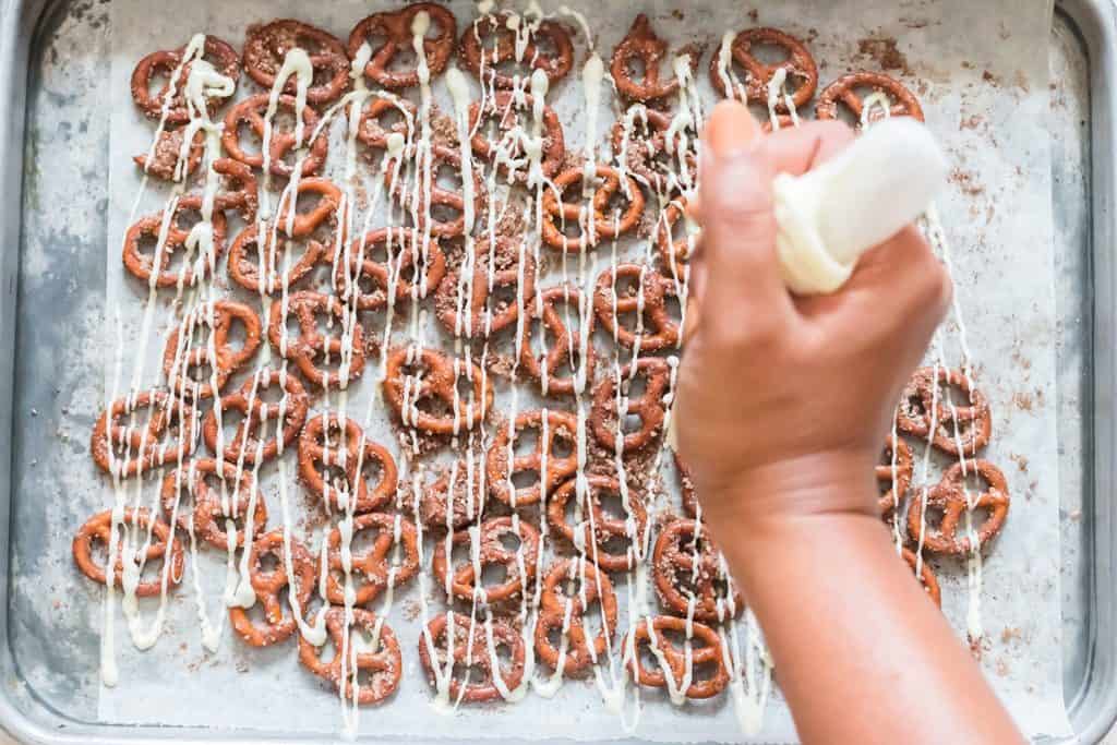 white chocolate drizzled over cinnamon sugar pretzels