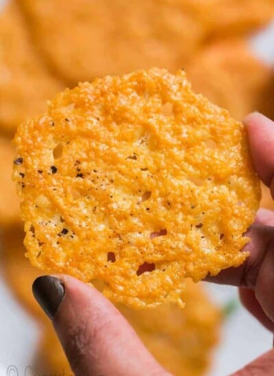 holding a crispy parmesan crisps