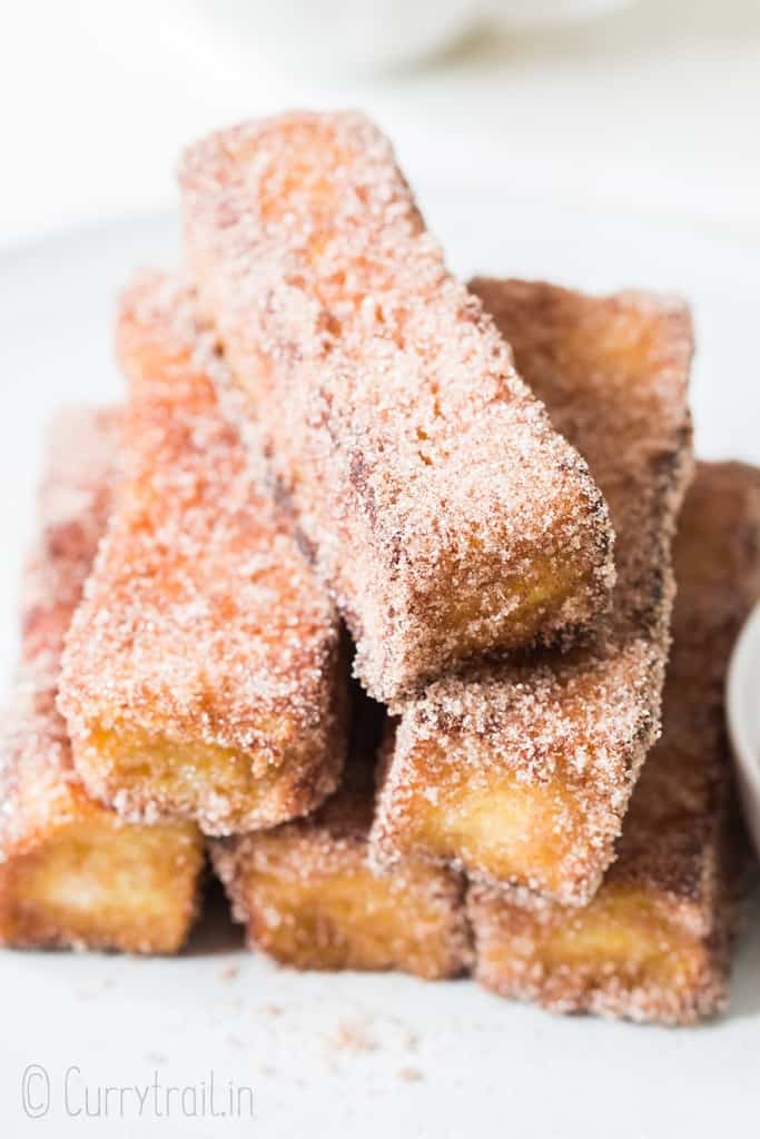 cinnamon french toast stick stacked on white plate