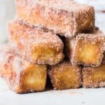 cinnamon french toast stick stacked on white plate