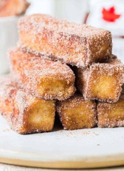 cinnamon french toast stick stacked on white plate