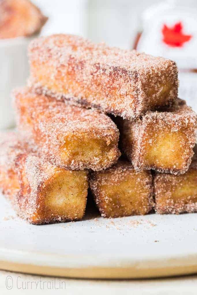 cinnamon french toast stick stacked on white plate