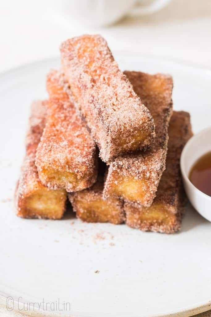 cinnamon french toast stick stacked on white plate