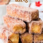 cinnamon french toast stick stacked on white plate with text overlay