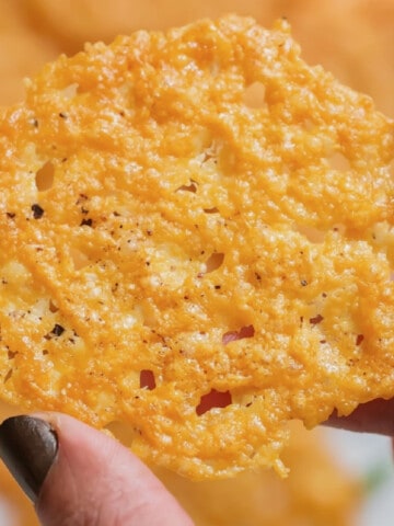 holding a crispy parmesan crisp.