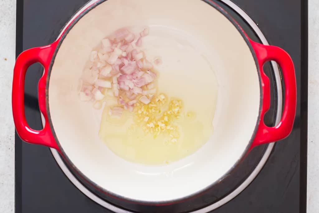 sautéing garlic and onions in olive oil in a skillet.