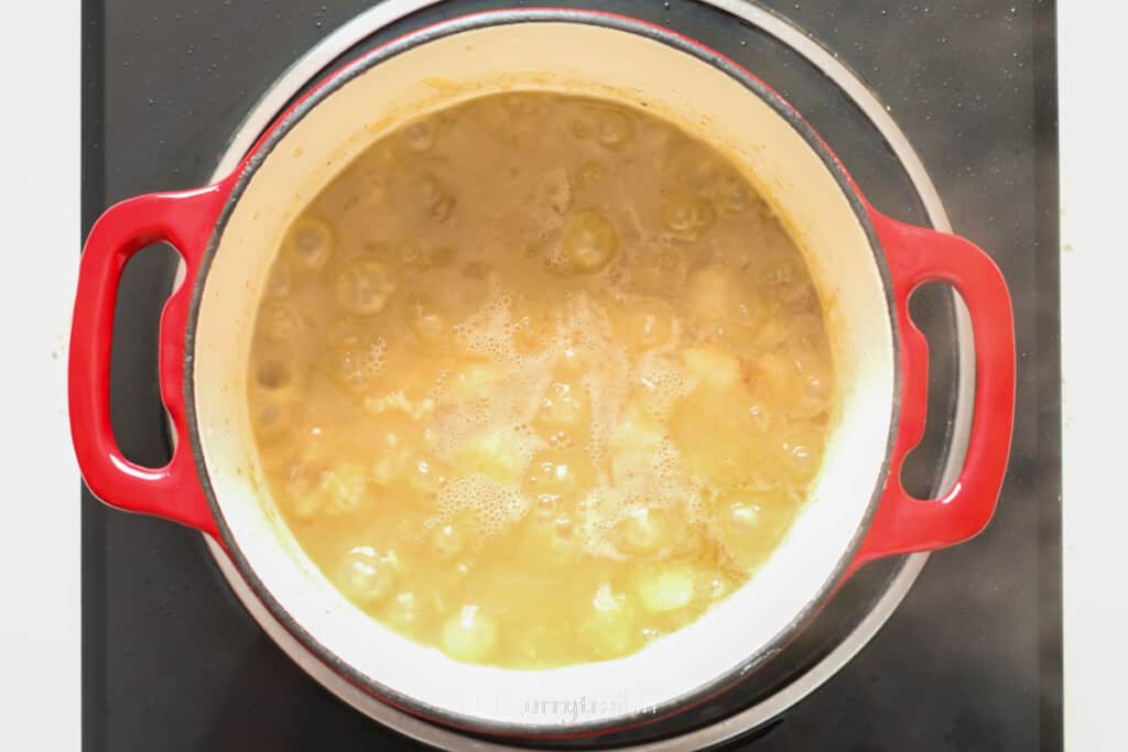 simmering browned lamb in chicken bone broth.