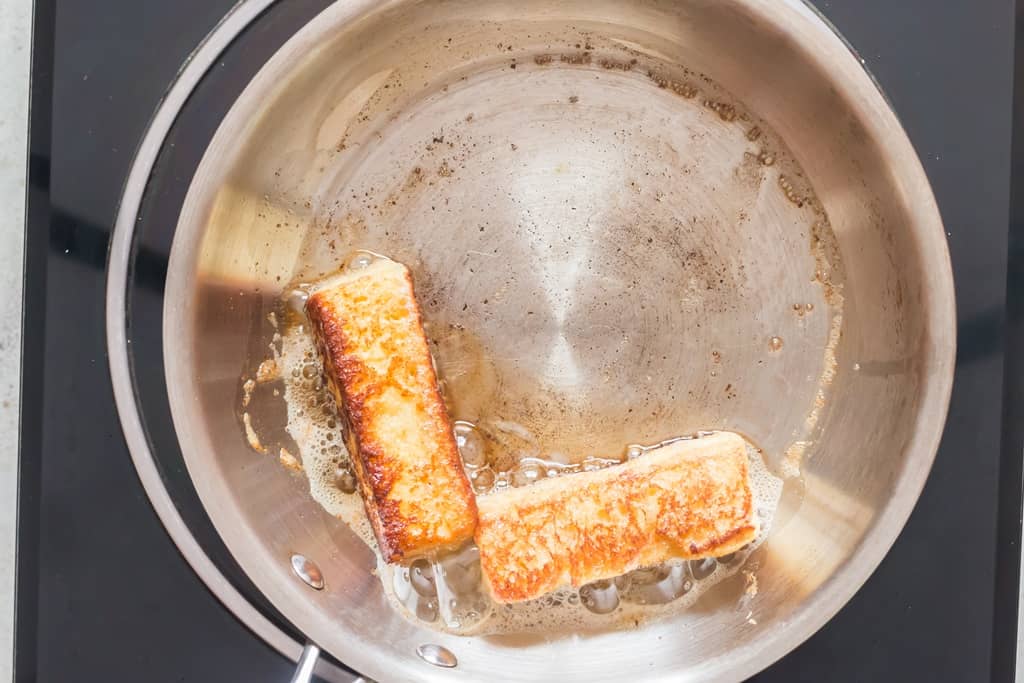 golden brown bread sticks in butter