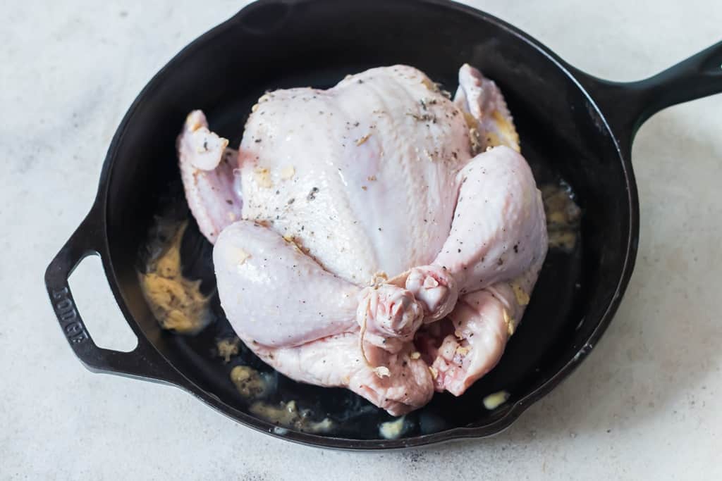 whole chicken before roasting in cast iron pan