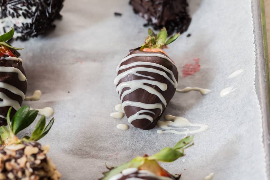 chocolate drizzle over chocolate covered strawberries.