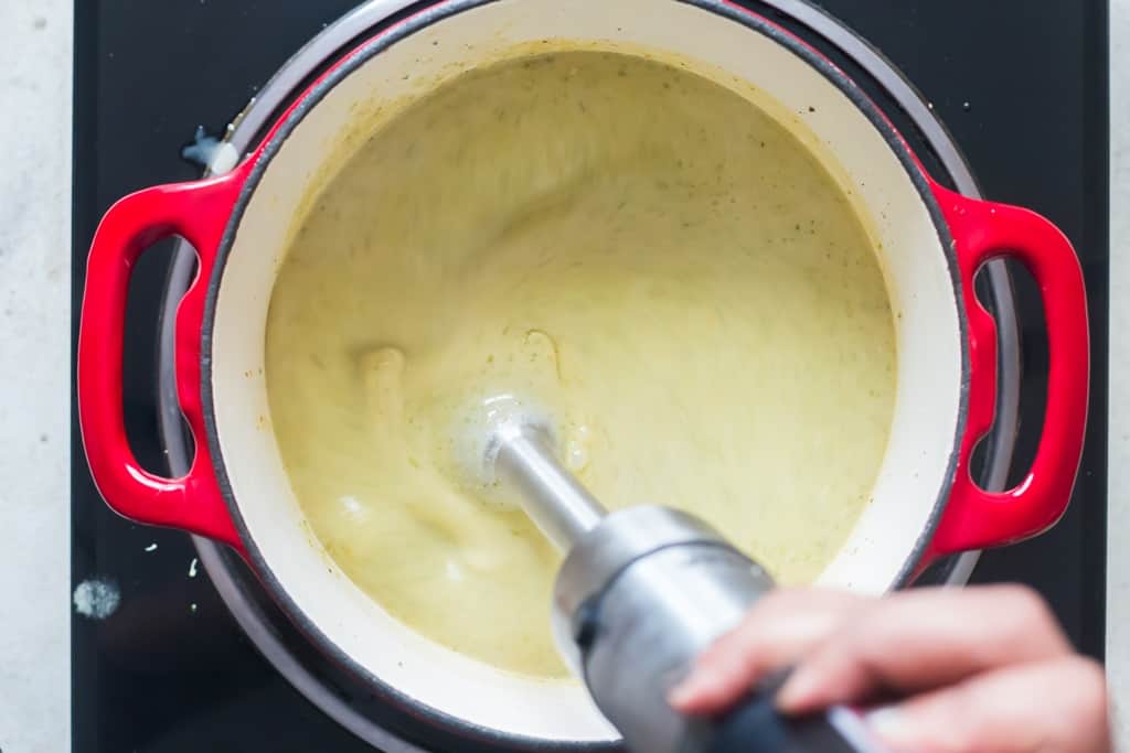 hand blender blending broccoli cheddar soup