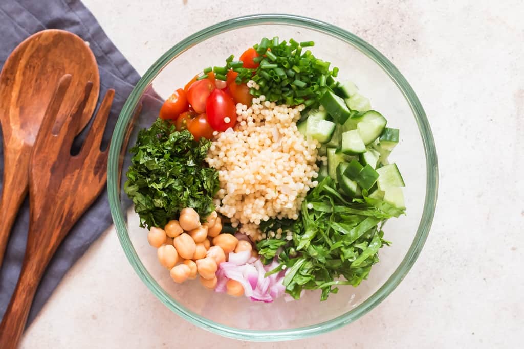 all the salad ingredients added to the salad mixing bowl.