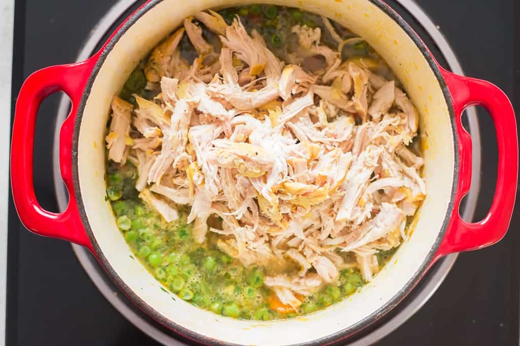 adding shredded chicken to make detox soup