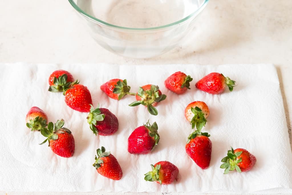 pat drying strawberries in paper towel