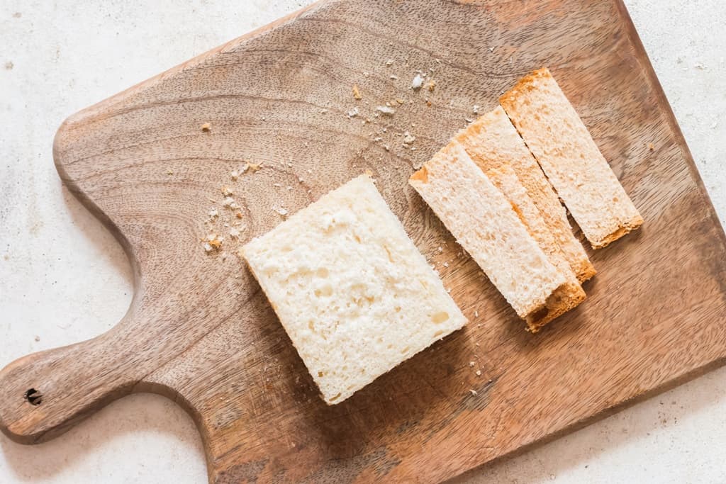 bread slices crust trimmed on wooden board