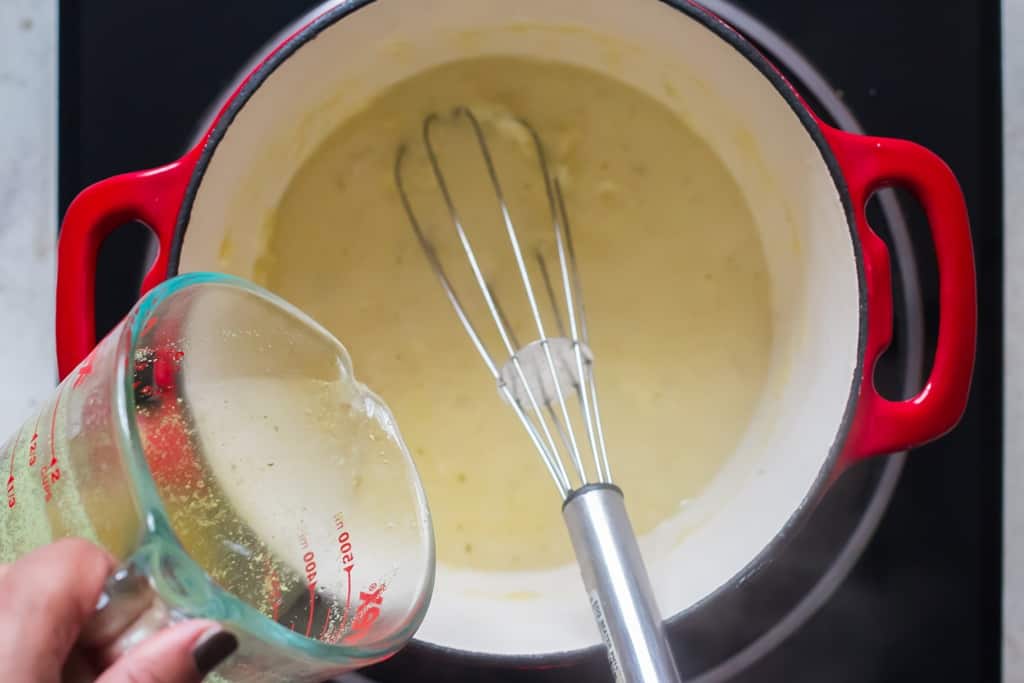 adding chicken stock to cook roux